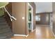 Inviting entryway showcases staircase, half-bath and wood-look floors at 1106 E Altadonna St, San Tan Valley, AZ 85140