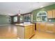 Open kitchen with island bar, sliding glass door, and modern appliances at 1106 E Altadonna St, San Tan Valley, AZ 85140