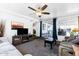 Cozy living room featuring a ceiling fan, entertainment center, and sliding glass doors to the patio at 111 S Greenfield Rd # 190, Mesa, AZ 85206