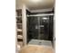 Modern bathroom with a large, tiled shower, sleek glass doors, and convenient built-in shelving at 11680 E Sahuaro Dr # 2011, Scottsdale, AZ 85259