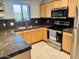 Well-lit kitchen with stainless steel appliances, granite countertops, and ample cabinet space at 11680 E Sahuaro Dr # 2011, Scottsdale, AZ 85259