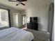 Comfortable main bedroom with soft natural light, carpeted floors, and a door to an outdoor balcony at 11680 E Sahuaro Dr # 2011, Scottsdale, AZ 85259