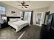 Bright main bedroom with a ceiling fan, a large bed, and access to a balcony through a glass door at 11680 E Sahuaro Dr # 2011, Scottsdale, AZ 85259