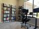 Home office featuring a sit/stand desk with computer and monitor, and lots of shelving for books at 11680 E Sahuaro Dr # 2011, Scottsdale, AZ 85259