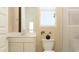 Well-lit bathroom with white cabinets, white countertop, toilet, shower with glass, and a neutral color scheme at 11940 W Calle De Pompas --, Peoria, AZ 85383