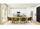 Bright dining area with modern table, chairs, and view of the open kitchen layout at 11940 W Calle De Pompas --, Peoria, AZ 85383