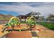 Community playground with modern equipment set against a backdrop of mountains and a stylish community center at 11940 W Calle De Pompas --, Peoria, AZ 85383