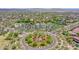 Aerial view of the community, showcasing a roundabout, pool, green spaces, and manicured landscaping at 12706 W Pasaro Dr, Peoria, AZ 85383