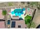 An aerial view that showcases a property's pool, fire pit, and solar panels on the roof at 12706 W Pasaro Dr, Peoria, AZ 85383