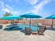 Backyard featuring a sparkling pool, sun umbrellas, and outdoor seating at 12706 W Pasaro Dr, Peoria, AZ 85383