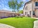 Lush backyard featuring manicured lawn and desert landscaping providing a serene outdoor living space at 12706 W Pasaro Dr, Peoria, AZ 85383