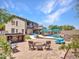 Beautiful backyard featuring a pool, firepit, outdoor kitchen, and lounge area perfect for entertaining at 12706 W Pasaro Dr, Peoria, AZ 85383