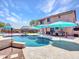 Spacious backyard with a sparkling swimming pool and comfortable seating areas at 12706 W Pasaro Dr, Peoria, AZ 85383