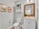 A stylish bathroom features a single sink vanity with decorative mirror and ample storage space at 12706 W Pasaro Dr, Peoria, AZ 85383