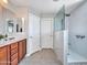 A renovated bathroom with a sleek design, includes a double vanity, and a modern walk-in shower with glass surround at 12706 W Pasaro Dr, Peoria, AZ 85383