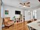 A cozy bedroom featuring hardwood floors, a ceiling fan, and plenty of space for relaxation and entertainment at 12706 W Pasaro Dr, Peoria, AZ 85383