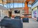 Comfortable Community Center area featuring plush couches, a fireplace, and a large screen TV at 12706 W Pasaro Dr, Peoria, AZ 85383