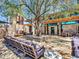 Inviting Community Center patio with comfortable seating, a fireplace, and lush landscaping for relaxation at 12706 W Pasaro Dr, Peoria, AZ 85383