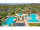 Expansive aerial view of community pools with slides, cabanas, palm trees, and well-kept grounds at 12706 W Pasaro Dr, Peoria, AZ 85383