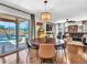 A dining area with hardwood floors adjacent to a living room and outdoor pool, perfect for entertaining guests at 12706 W Pasaro Dr, Peoria, AZ 85383