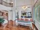 Open dining room with a modern table and bench seating, chandelier lighting, and views to the living area at 12706 W Pasaro Dr, Peoria, AZ 85383