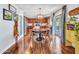 An inviting dining room with hardwood floors, a stylish light fixture, and easy access to the kitchen at 12706 W Pasaro Dr, Peoria, AZ 85383