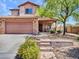Charming two-story home features a covered front porch, desert landscaping, and a two-car garage at 12706 W Pasaro Dr, Peoria, AZ 85383