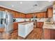 A spacious kitchen features stainless steel appliances, granite countertops, and a center island for food preparation at 12706 W Pasaro Dr, Peoria, AZ 85383