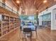Inviting library space with wooden ceiling, stone accent wall, and comfortable seating near large windows at 12706 W Pasaro Dr, Peoria, AZ 85383
