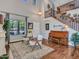 An elegant living room with tall ceilings, a grand staircase, and hardwood floors throughout at 12706 W Pasaro Dr, Peoria, AZ 85383