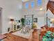 Stunning living room with soaring ceilings, a decorative fireplace, and beautiful hardwood floors at 12706 W Pasaro Dr, Peoria, AZ 85383