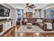 A spacious living room boasts hardwood floors, a ceiling fan, and a comfortable sectional sofa at 12706 W Pasaro Dr, Peoria, AZ 85383