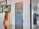 A pantry door with frosted design and a view of a stainless steel refrigerator and decorated wall at 12706 W Pasaro Dr, Peoria, AZ 85383