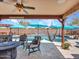 Outdoor patio with seating, ceiling fan, hanging hammock, and an inviting swimming pool at 12706 W Pasaro Dr, Peoria, AZ 85383