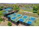 Aerial view of community pickleball courts with desert landscaping and mountain views in a desirable neighborhood at 12706 W Pasaro Dr, Peoria, AZ 85383