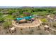 Aerial view of a colorful, shaded playground with picnic areas, offering a fun outdoor space for families at 12706 W Pasaro Dr, Peoria, AZ 85383