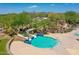 Aerial view of a water slide feature, surrounded by desert landscaping and a small pool at 12706 W Pasaro Dr, Peoria, AZ 85383