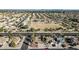 Expansive aerial view of a well-maintained community with lush landscaping and a central park area at 13051 N 75Th Dr, Peoria, AZ 85381