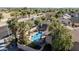 Aerial view showcasing a refreshing backyard pool, complete with a slide, gazebo, trampoline, and lush landscaping at 13051 N 75Th Dr, Peoria, AZ 85381