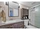 Bathroom featuring a vanity, modern mirror, and shower with glass door at 13051 N 75Th Dr, Peoria, AZ 85381