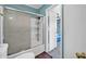 Clean bathroom featuring a shower with glass doors, white fixtures, and blue walls at 13051 N 75Th Dr, Peoria, AZ 85381
