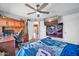 Cozy bedroom featuring a ceiling fan, built-in desk, and comfortable bedding with racing theme at 13051 N 75Th Dr, Peoria, AZ 85381