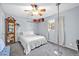 Bright bedroom features a ceiling fan, neutral carpet, and ample natural light at 13051 N 75Th Dr, Peoria, AZ 85381