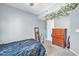 Serene bedroom with light gray walls, a ceiling fan, and a dresser with a plant above it at 13051 N 75Th Dr, Peoria, AZ 85381