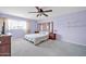 Spacious bedroom with a ceiling fan, two bedside tables and bright natural light at 13051 N 75Th Dr, Peoria, AZ 85381