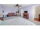 Bedroom features a ceiling fan, television and doorway access to a bedroom closet at 13051 N 75Th Dr, Peoria, AZ 85381