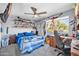 Unique bedroom with a blue theme, ceiling fan, large window, and a collection of model cars on shelving at 13051 N 75Th Dr, Peoria, AZ 85381