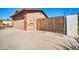 Exterior view of garage, privacy gate, and front concrete driveway of home at 13051 N 75Th Dr, Peoria, AZ 85381