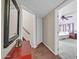 Hallway featuring a mirror, stairway access, and entry to an adjacent bedroom at 13051 N 75Th Dr, Peoria, AZ 85381