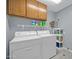 Laundry room with washer, dryer, shelving, and overhead storage at 13051 N 75Th Dr, Peoria, AZ 85381